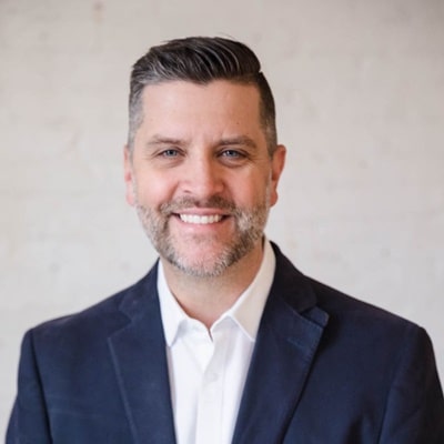 James Thole, professional copywriter, smiling in a blazer against a neutral background, representing expertise in conversion-focused web copy.